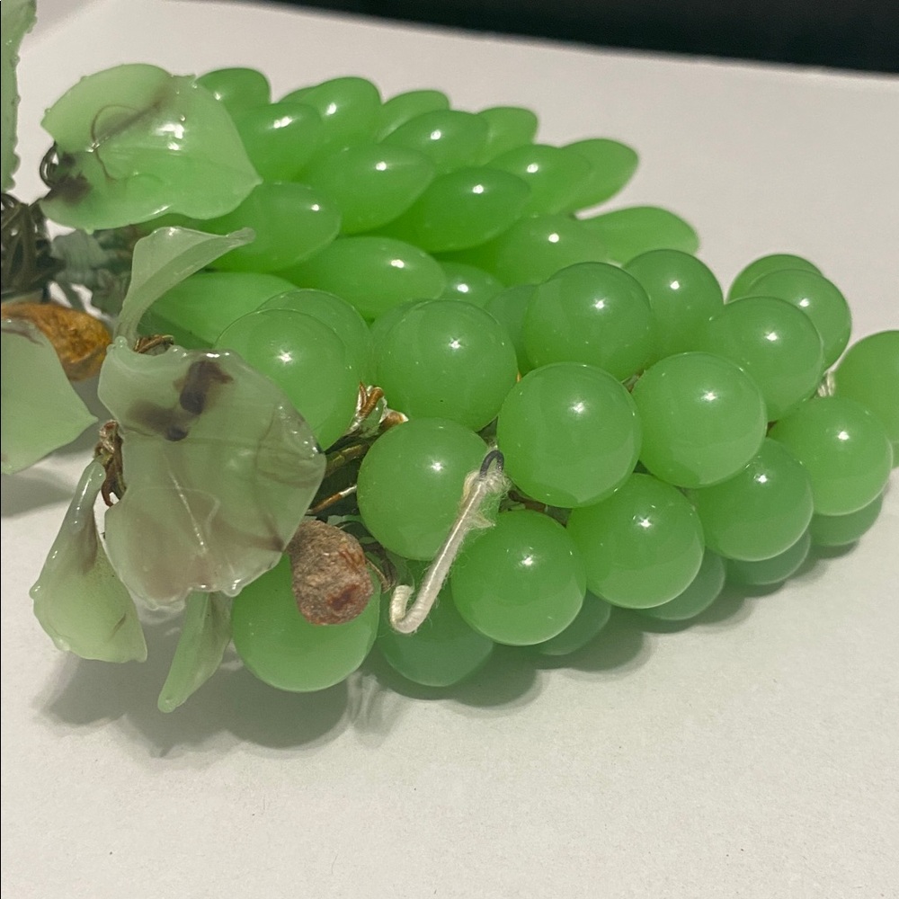 Vintage stone green grape clusters